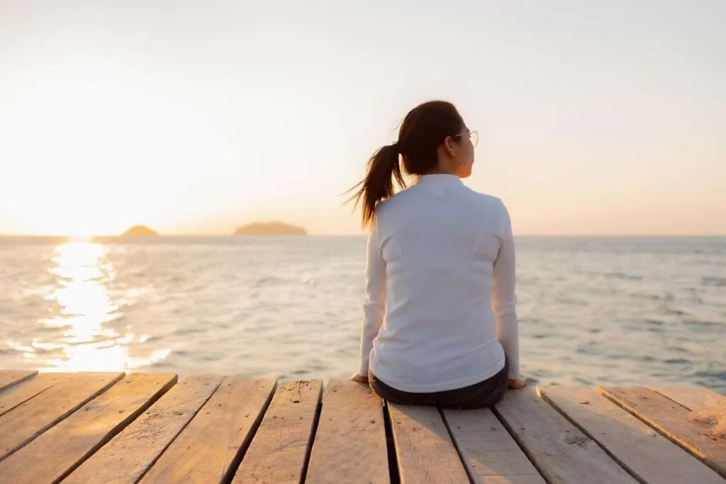 Women looking at the ocean wondering Why Am I Single
